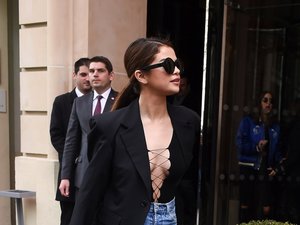 Selena Gomez w czarnej marynarce, bluzce z dekoltem i dżinsowej spódnicy